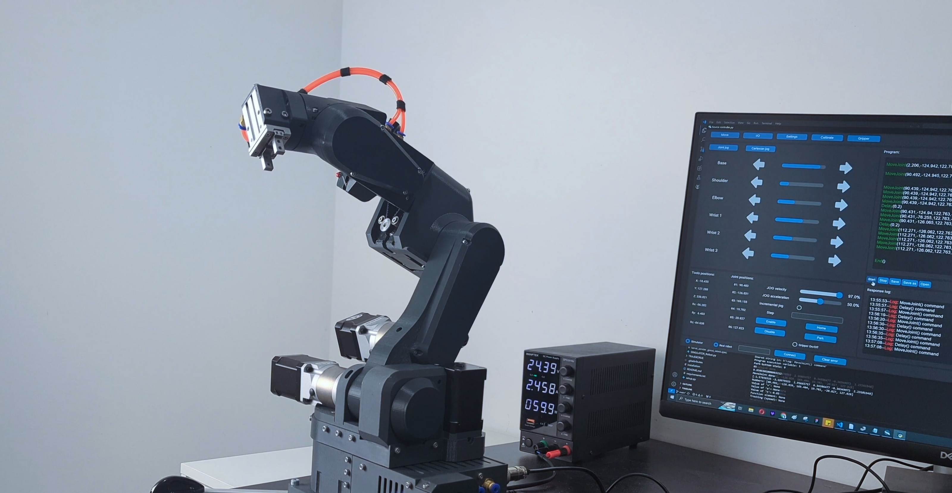 gray parol6 robot next to a commander software screen